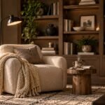 A bright, expansive view of a luxury home interior showcasing a cozy reading nook styled with a brown velvet chair, a round cream rug, and a tall statement plant, seamlessly blending into the open-concept living space.
